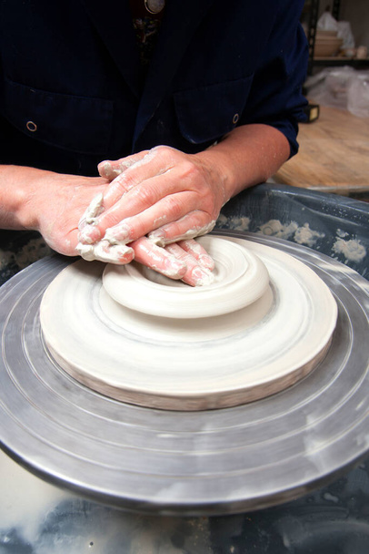 A lady ceramics artist at work in her home pottery studio, opening up - Fotoğraf, Görsel
