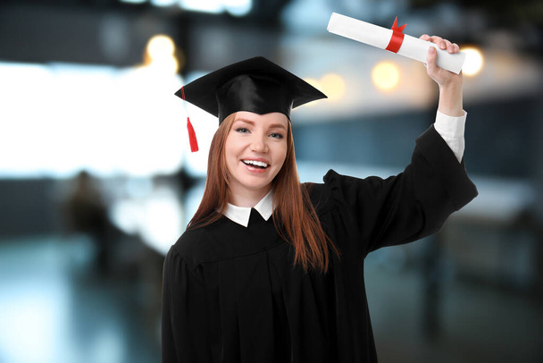 Happy student with graduation hat and diploma in office - Foto, Bild