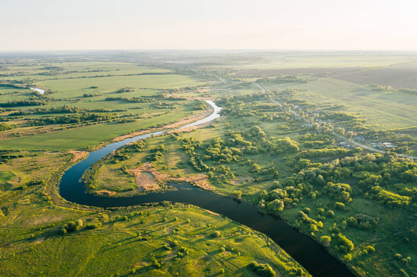 Small russian village in green countryside near river bend at sunset, panoramic aerial view. Rural summer landscape in Penza Oblast, Russia - Fotografie, Obrázek