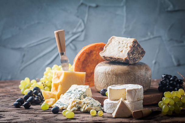 various types of cheese on rustic wooden table - Fotoğraf, Görsel