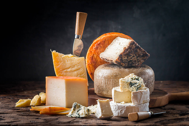 various types of cheese on rustic wooden table - Foto, immagini