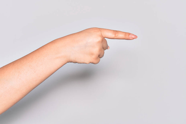 Hand of caucasian young woman pointing with index finger to the side, suggesting and selecting a choice - Photo, Image