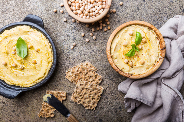 Healthy Homemade Creamy Hummus with Olive Oil over stone background, top view - Fotografie, Obrázek