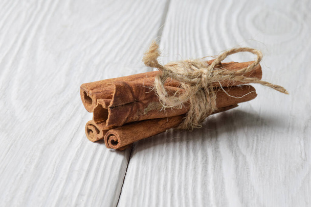 cinnamon on the wood table - Фото, изображение