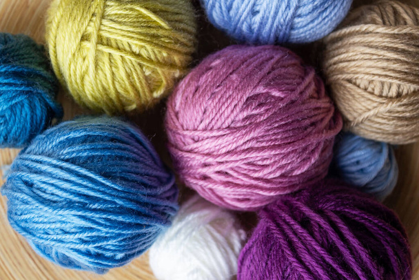 Close-up top view of multicolored woolen balls. - Foto, Bild