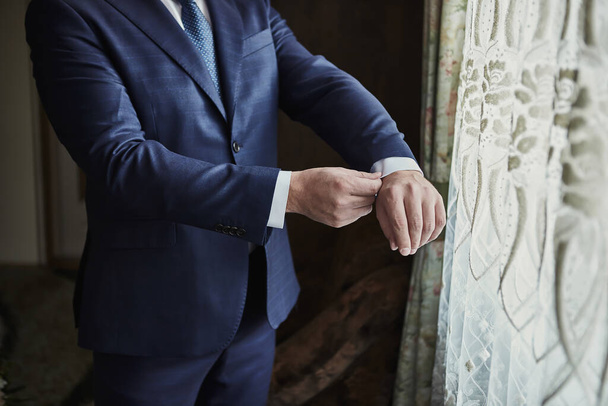 Бізнесмен носить піджак, чоловічі руки крупним планом, підготуватися вранці перед церемонією одруження
 - Фото, зображення