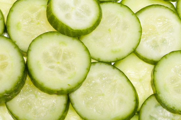 Freshly sliced cucumber isolated on white background - Photo, Image