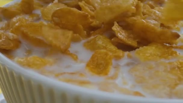 Close-up shot, Breakfast Cereal in a white bowl, corn flakes fall into a bowl, - Video