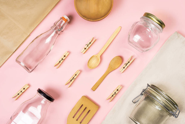 Zero waste concept. Textile eco bags, craft bag, glass jars, wooden kitchen appliances on a pink background Eco friendly and reuse concept. Top view or flat lay - Foto, Bild