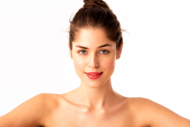 Headshot of beautiful young woman with flawless skin wearing red lipstick while posing at isolated white background.  - Φωτογραφία, εικόνα