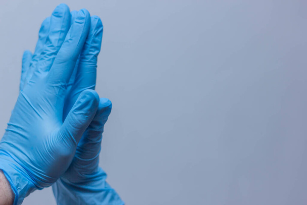 blue vinyl gloves on white background stay home - Fotó, kép