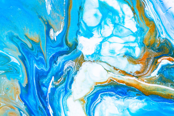 Fluid art texture. Abstract backdrop with iridescent paint effect. Liquid acrylic picture with flows and splashes. Mixed paints for baner or wallpaper. Blue, golden and white overflowing colors. - Foto, Imagem