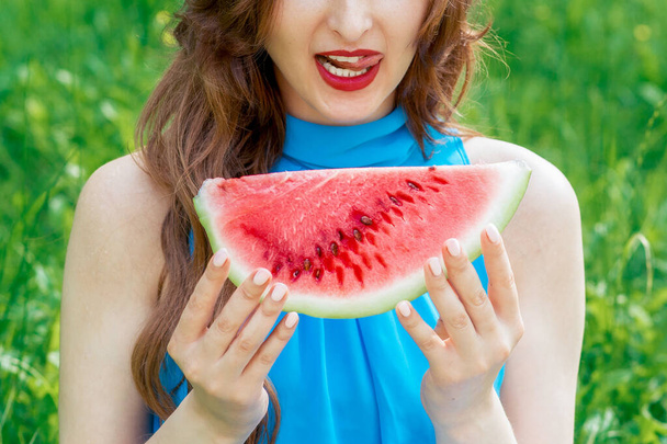 Pretty woman is holding slice of watermelon outdoors. - Photo, Image