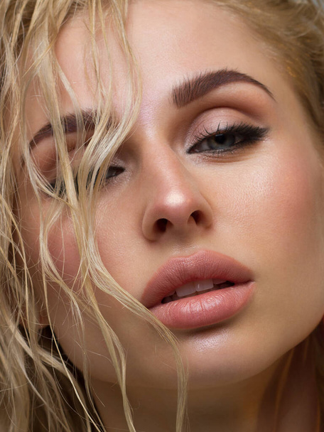 Glamour portrait of beautiful woman model with fresh daily makeup. Fashion shiny highlighter on skin, sexy gloss lips make-up and perfect eyebrows. Natural beauty - Zdjęcie, obraz