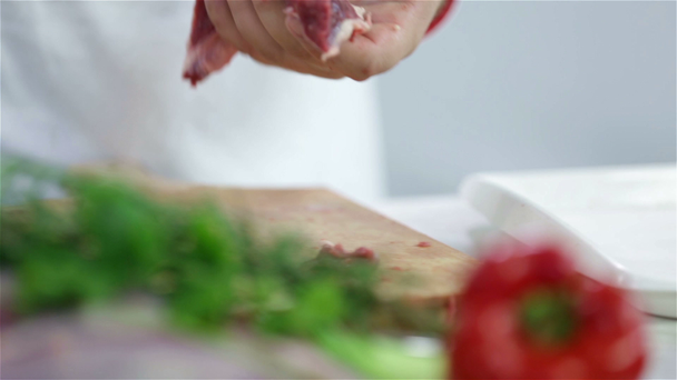 Sliding through chef's table while arranging meat on plate - Footage, Video