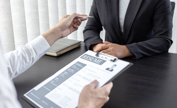 HR head is reading the resume and information about the candidate's history, Field employers are interviewing job applicants and negotiating agreements, Recruitment and job applications concept. - Photo, Image