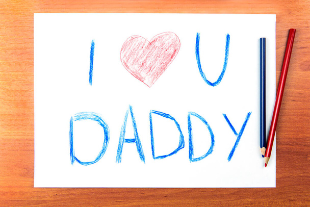 Fathers day concept. Composition with childs drawing with words I Love U Daddy and pencils. - 写真・画像