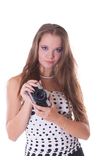 Young female model in polka dot dress posing with 35mm camera - Foto, Imagem