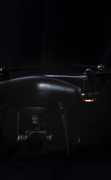 black drone and silver camera on black background - Photo, Image