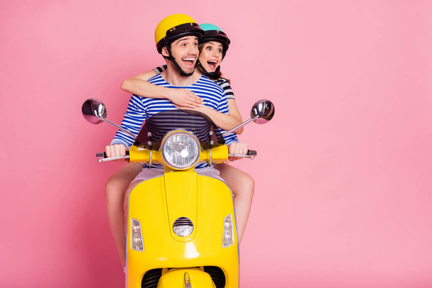 Portrait of his he her she nice attractive lovely successful cheerful cheery amazed couple riding moped having fun rent rental service transport isolated on pink pastel color background - Fotografie, Obrázek