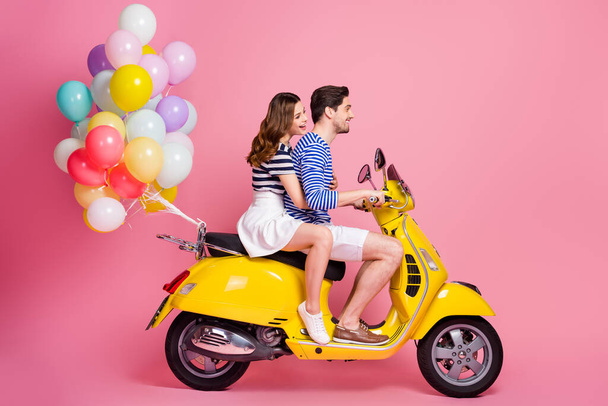 Profile side view portrait of his he her she nice attractive cheerful cheery glad couple riding moped delivering air balls party organization isolated on pink pastel color background - Foto, Imagem