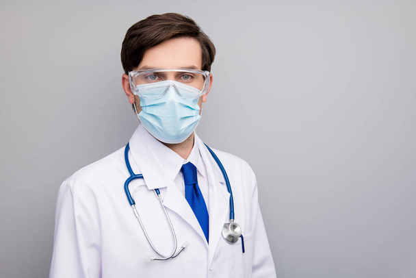 Photo of attractive handsome serious doc guy professional experienced skilled surgeon wear facial protective mask medical uniform lab coat stethoscope isolated grey background - Foto, Bild