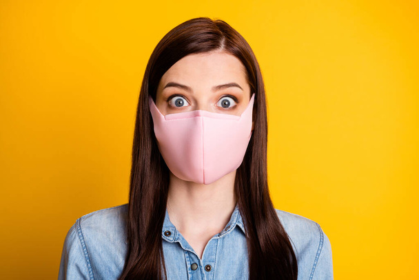 Portrait of astonished girl hear horrible quarantine prolong news impressed wear medical mask isolated over bright color background - Фото, зображення