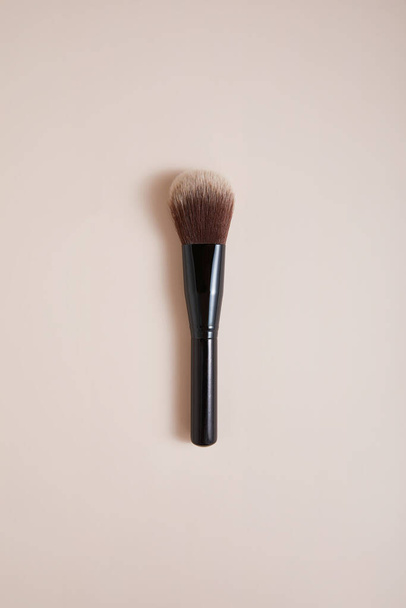 professional face makeup brush on beige background, close view, beauty concept  - Фото, зображення