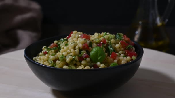 Served salad of pasta ptitim with vegetables. Close up. - Πλάνα, βίντεο