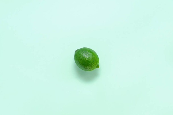 one fresh juicy bright lime on a gentle mint light background with copy space. citrus vitamin C healthy eating and minimal lifestyle. blank for postcards banner and menu - Photo, image
