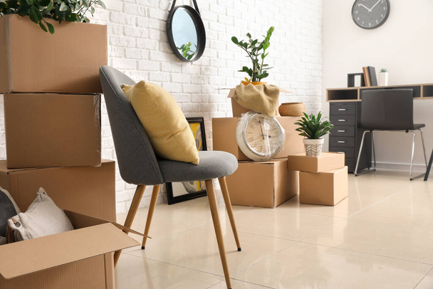 Cardboard boxes with belongings in new flat on moving day - Photo, Image