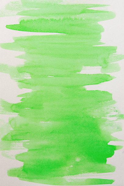 Watercolor background fill in a soft green color. Beautiful movement in the brush on watercolor paper. Handmade work. Unique performance. Creative watercolor background - Foto, Bild