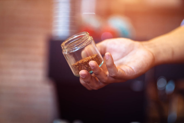 Barista show coffee beans in drip glass. - Fotó, kép