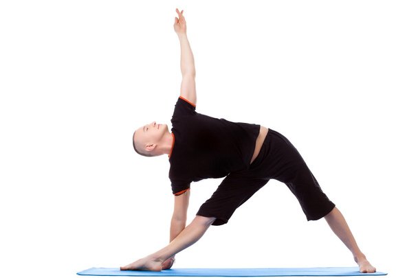 Energetic middle-aged man doing yoga poses - Foto, Bild