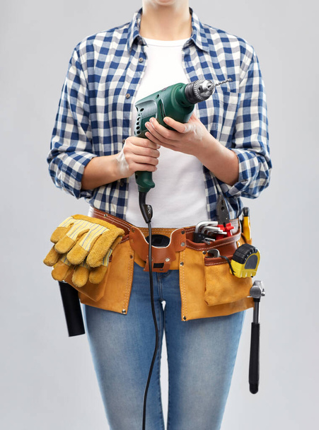 γυναίκα ή οικοδόμος με εργαλεία τρυπανιού και εργασίας - Φωτογραφία, εικόνα