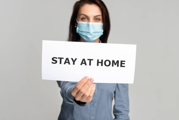 Woman with paper banner stay at home during quarantine - Foto, immagini