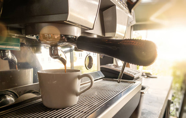 Close-up of espresso pouring from coffee machine by Professional coffee brewing. - Photo, Image