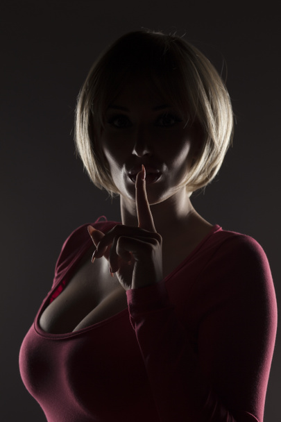 silhouette of blonde with a finger on her lips - Foto, imagen