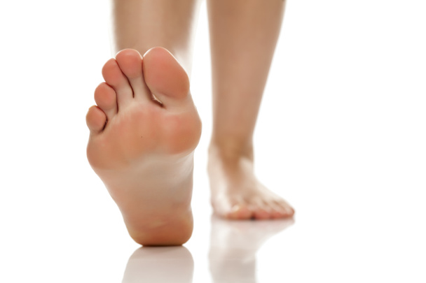 female bare feet on white background - Foto, afbeelding