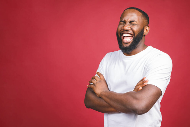 Portrait of African American man laughing isilated over red.  - Foto, afbeelding