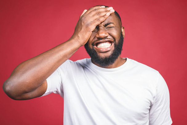 Portrait of African American man laughing isilated over red.  - 写真・画像