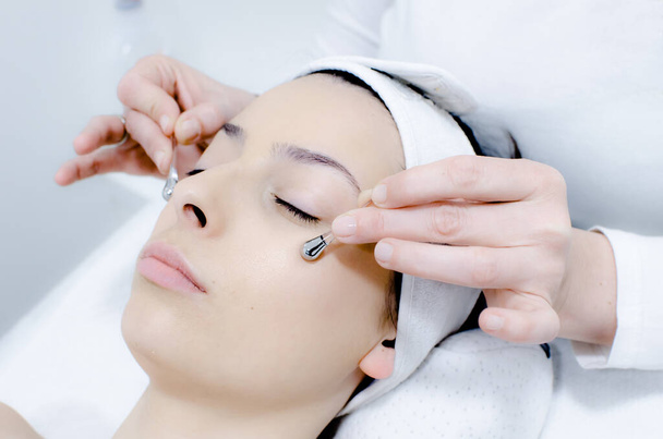 collagen treatment for area around the eyes with special sticks, procedure of regeneration and rejuvenation of the skin in beauty salon, close up  - Photo, Image