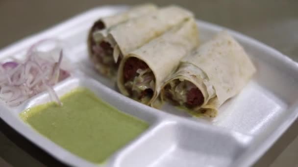 Street style mutton seekh roll in wrapped in Rumali with onion and mint sauce. - Footage, Video