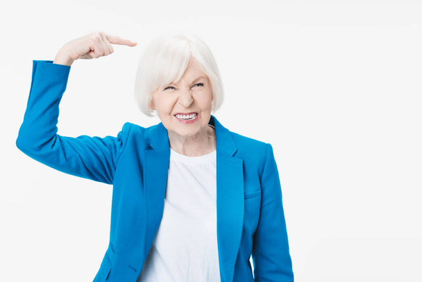 Senior woman doing funny gesture standing over isolated white background - Photo, image