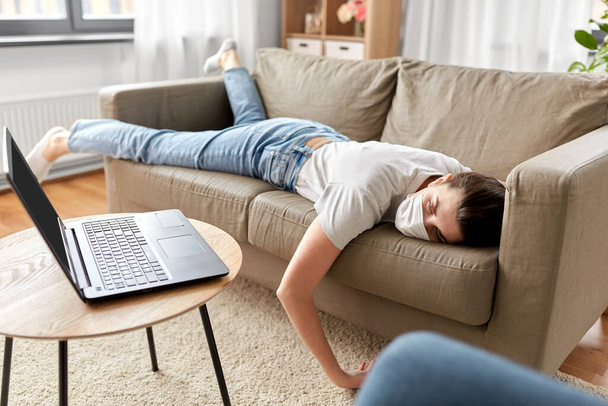 sick bored woman with laptop lying on sofa at home - Photo, Image