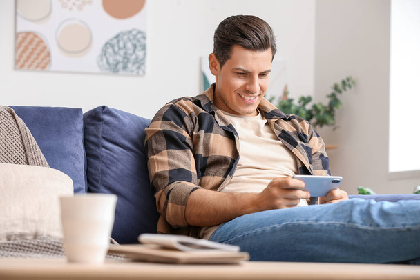 Lazy man with mobile phone spending day off at home - Photo, image