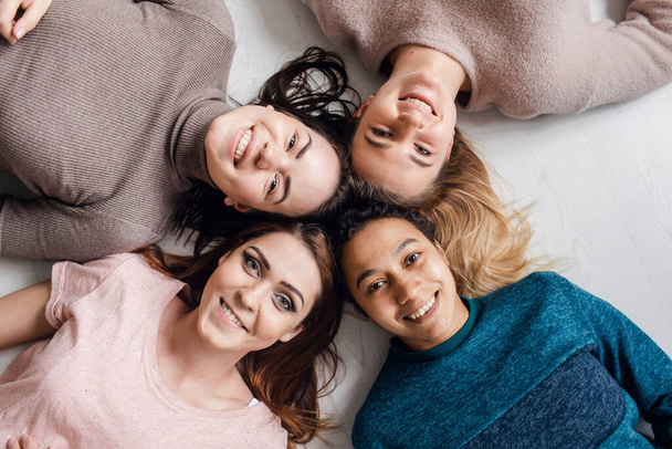 Four best girls friends talking at home. girls spend time together and have fun - Фото, зображення