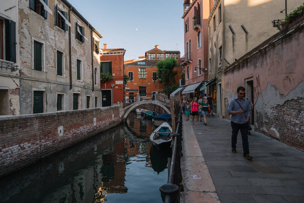Venice, Italy - August 13, 2016: Tourists are walking by the canal of Venice, Italy. - Photo, image