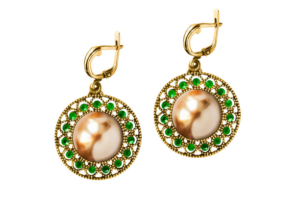 Luxury gold earrings with golden pearl and green gems isolated over white - Foto, Bild