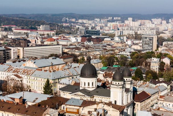 LVIV, UKRAINE - OCTOBER 23, 2019: aerial view of city with dominican church surrounded by old buildings - Fotó, kép
